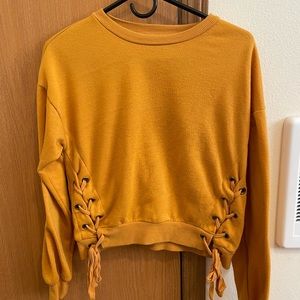 Yellow sweater with lace-up sides